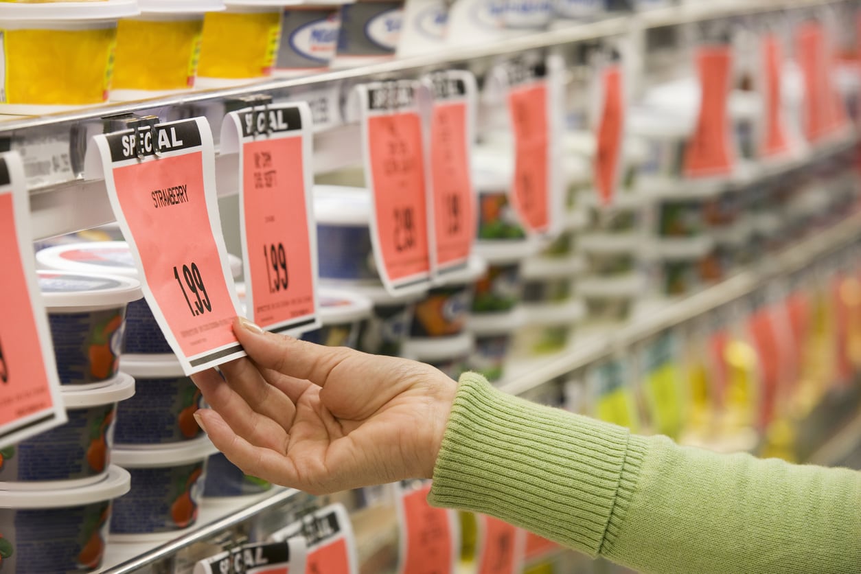 Woman looking at grocery store deals on strawberries