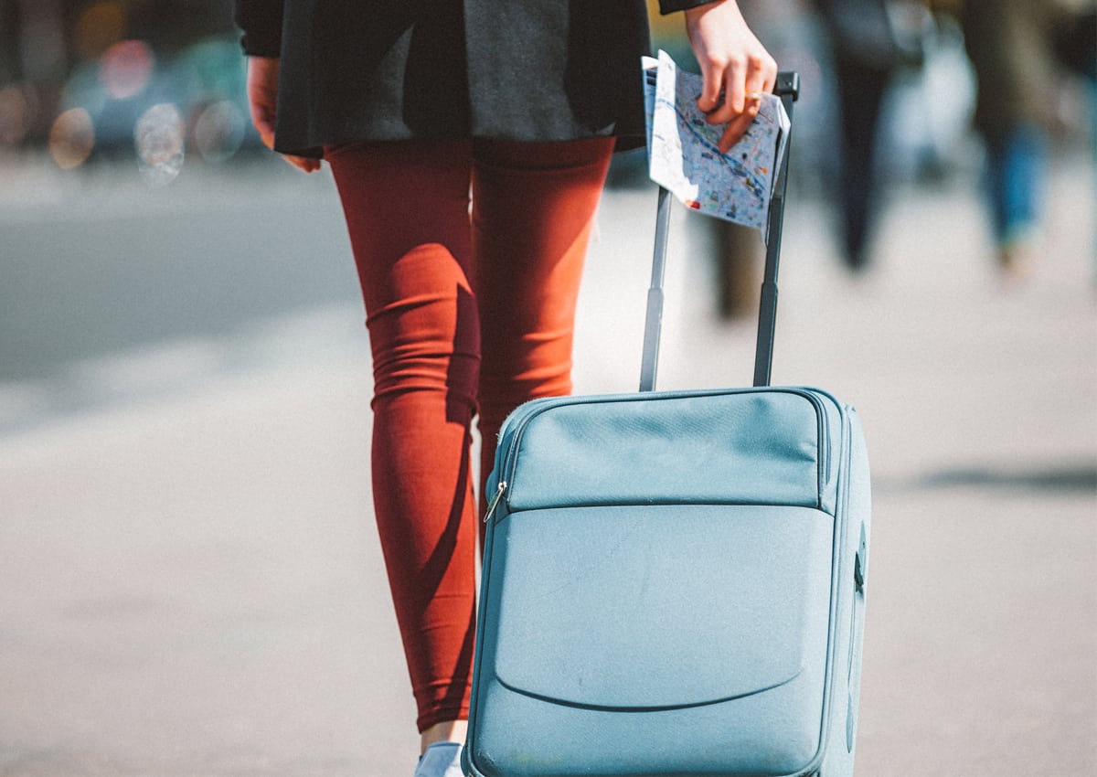 Woman carrying a suitcase