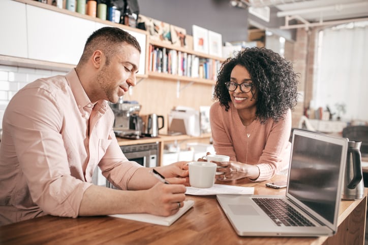 Couple working on their finances with spreadsheets