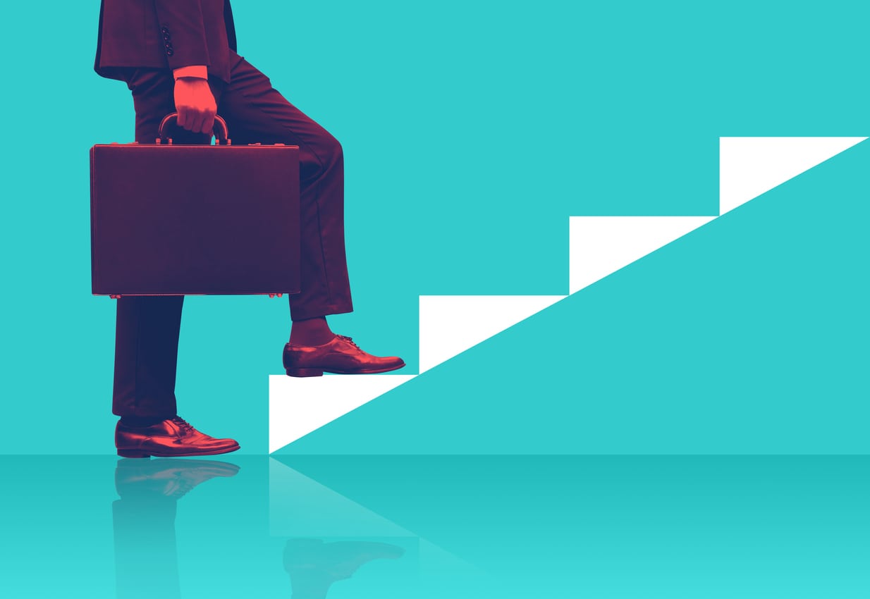 Businessman holding briefcase walking on graphic stairs