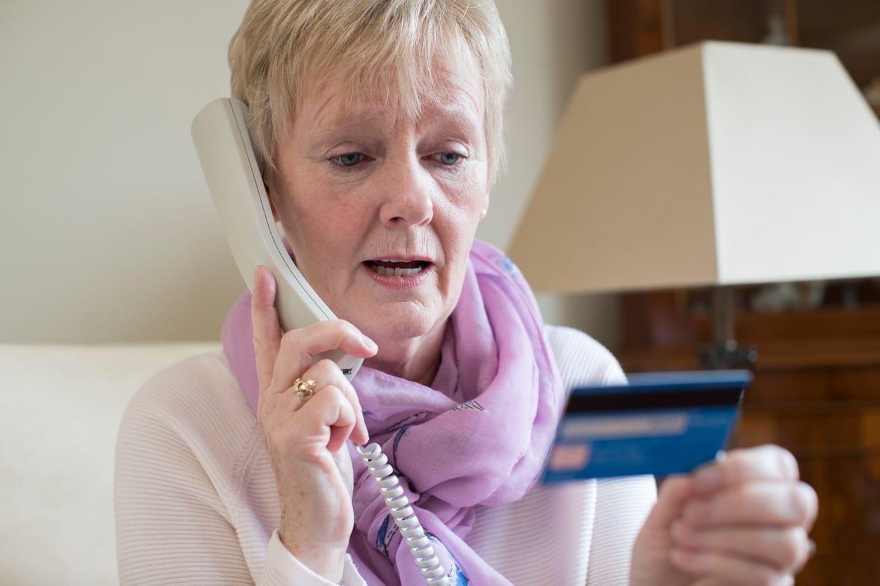 Old lady giving away credit card information on the phone