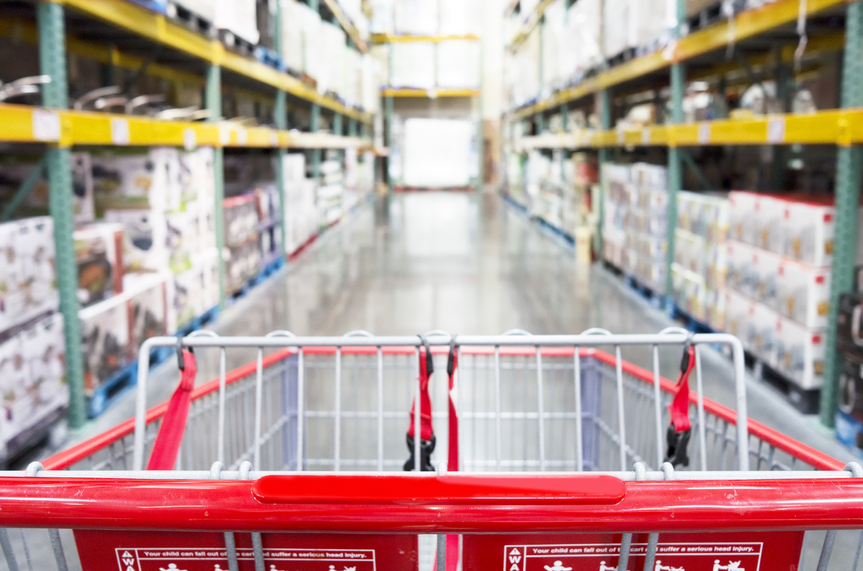 Grocery cart going down a store aisle