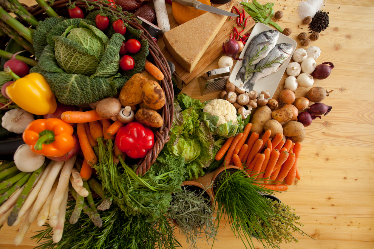 A basket of fresh vegetables and fish