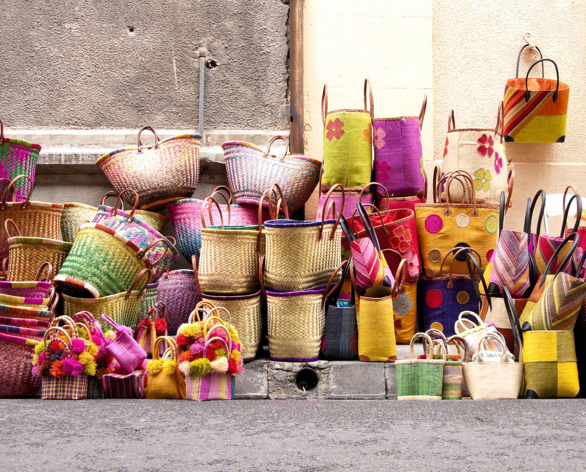 A pile of handbags for sale on the street