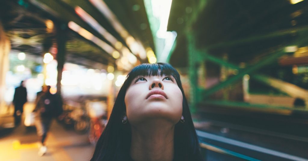 Young woman looking up thinking about life