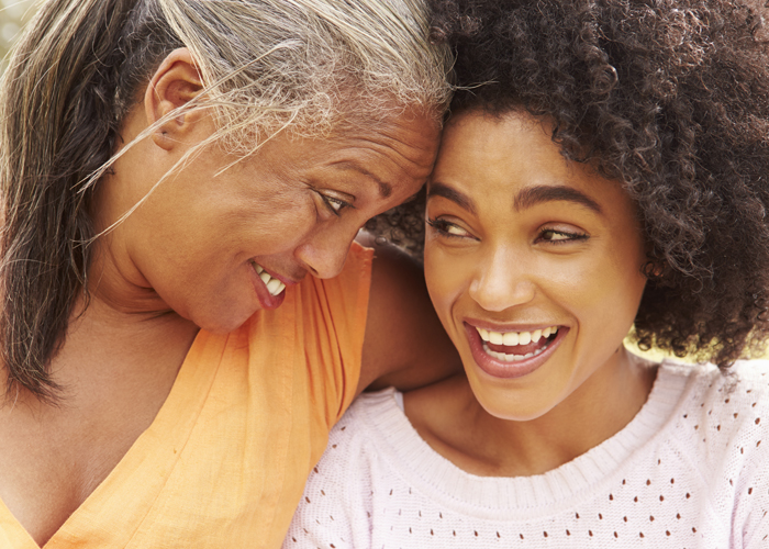 Mother and daughter smiling