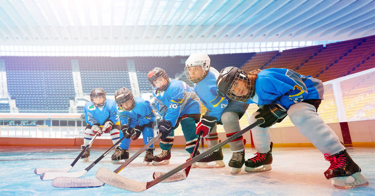 Children in hockey gear on ice ready to play