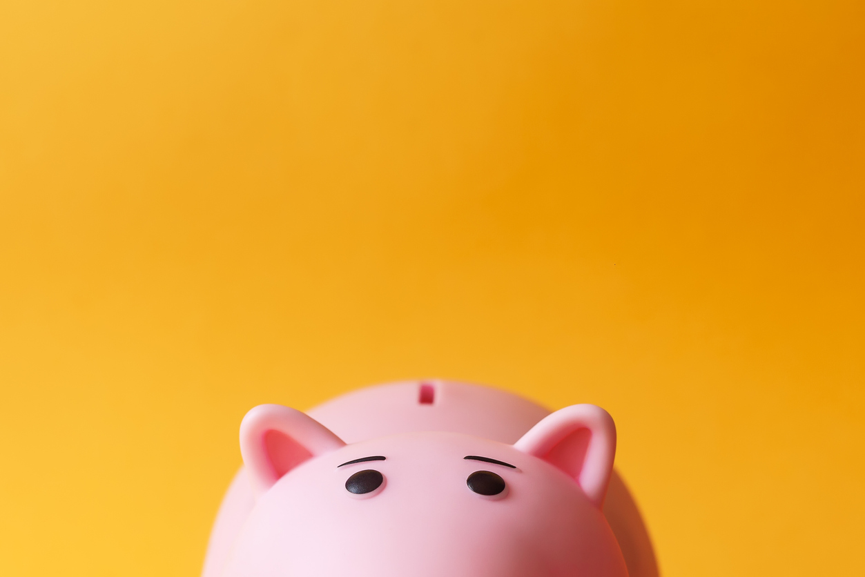 Pink piggy bank with an orange background