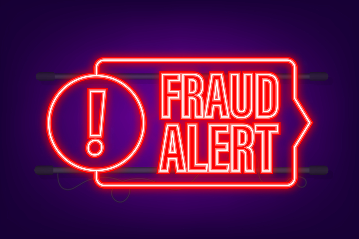 A neon sign that says fraud alert.